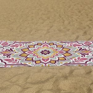 white beach towel psd mockup laying on the sand