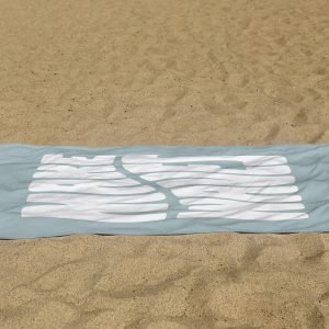 white beach towel psd mockup laying on the sand