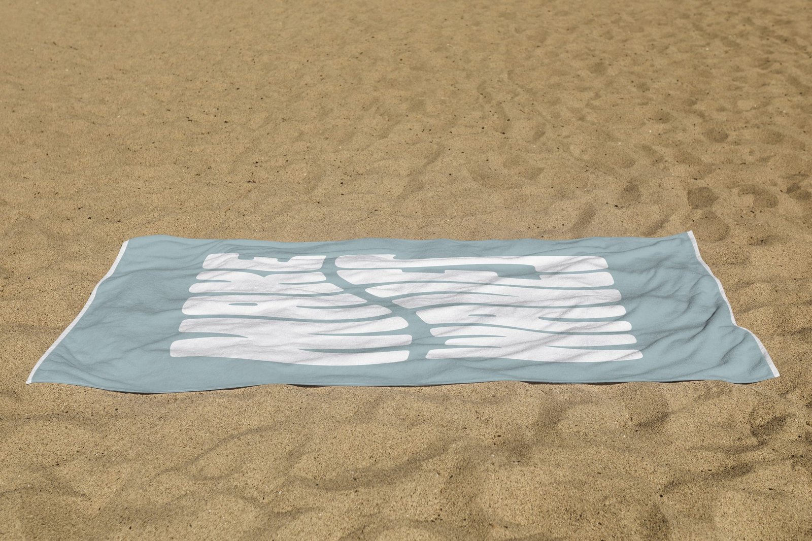 white beach towel psd mockup laying on the sand white beach towel psd mockup laying on the sand