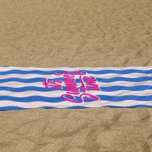 white beach towel psd mockup laying on the sand